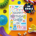 Birthday card with colorful text and illustrations surrounded by dog toys and treats on a multicolored background.